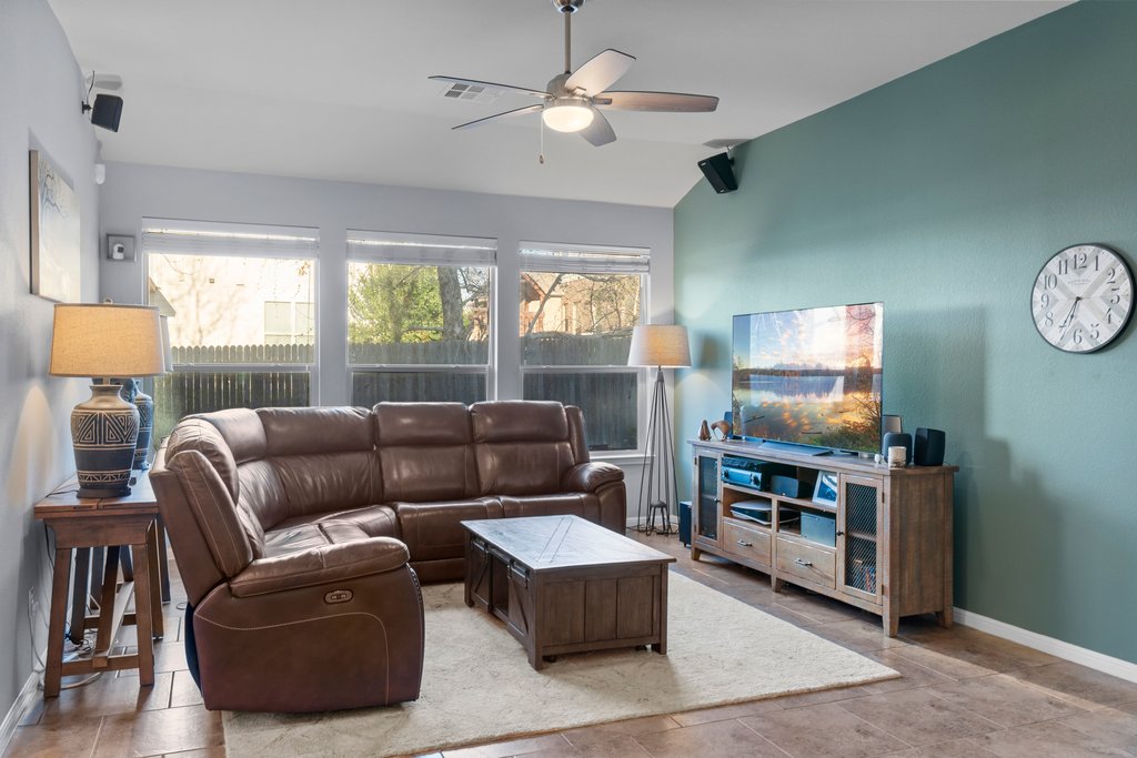 2902 Tempe Drive Cedar Park, TX 78641 - Photo 12 of 38 Living room featuring a ceiling fan and vaulted ceiling