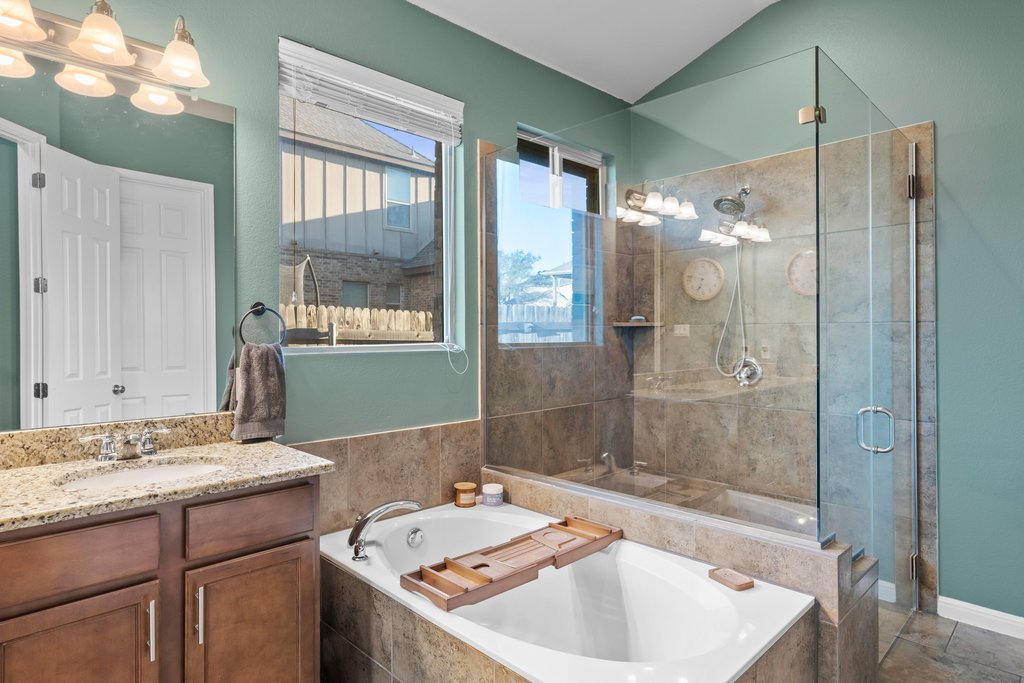 2902 Tempe Drive Cedar Park, TX 78641 - Photo 20 of 38 Bathroom featuring a shower stall, a bath, and vanity