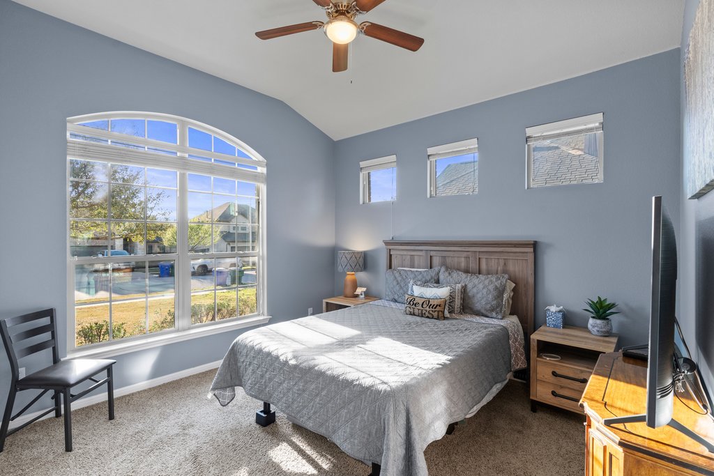 2902 Tempe Drive Cedar Park, TX 78641 - Photo 23 of 38 Bedroom featuring carpet flooring, multiple windows, a ceiling fan, and vaulted ceiling