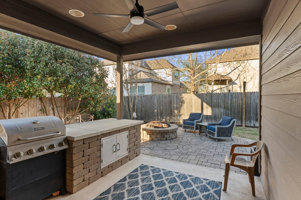 2902 Tempe Drive Cedar Park, TX 78641 - Photo 30 of 38 Fenced backyard with a ceiling fan, an outdoor fire pit, a patio area, and area for grilling