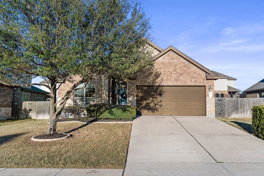 2902 Tempe Drive Cedar Park, TX 78641 - Photo 4 of 38 View of front of home featuring an attached garage, brick siding, and concrete driveway