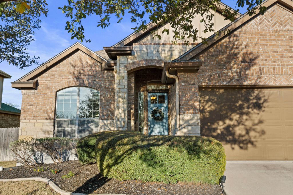 2902 Tempe Drive Cedar Park, TX 78641 - Photo 5 of 38 Entrance to property with brick siding, a garage, and concrete driveway