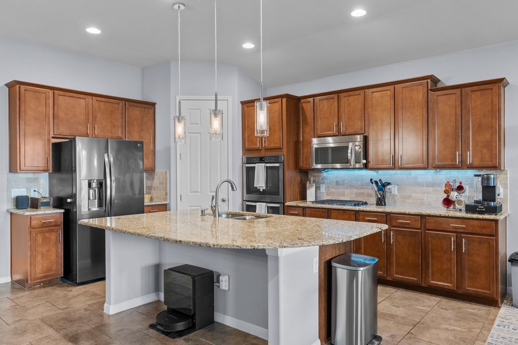 2902 Tempe Drive Cedar Park, TX 78641 - Photo 9 of 38 Kitchen featuring wood finish cabinets, backsplash, and stainless steel appliances