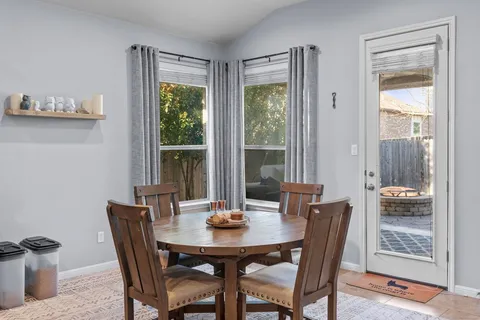 a view of a dining room with furniture and chandelier
