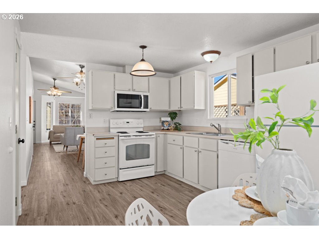 4482 Southwest 179th Avenue Beaverton, OR 97078 - Photo 12 of 37 a kitchen with a sink stove and cabinets