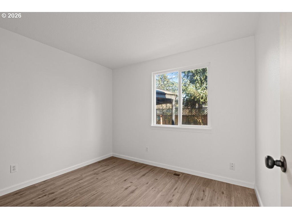 4482 Southwest 179th Avenue Beaverton, OR 97078 - Photo 23 of 37 an empty room with wooden floor and windows