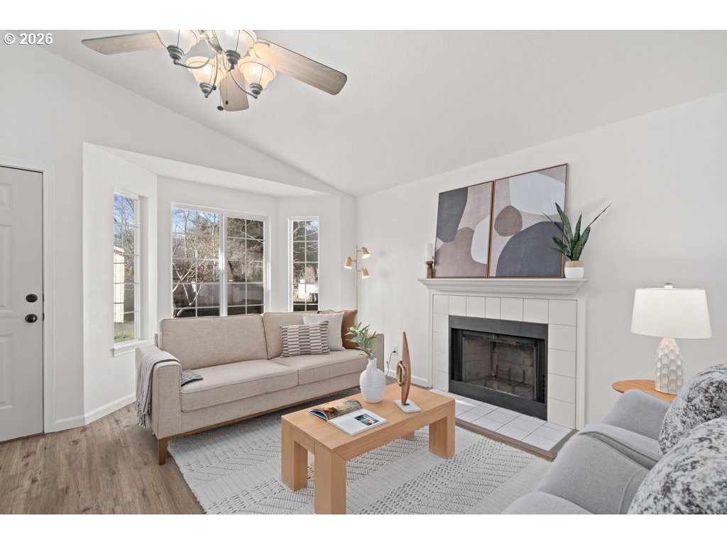 4482 Southwest 179th Avenue Beaverton, OR 97078 - Photo 3 of 37 a living room with furniture a fireplace and a chandelier