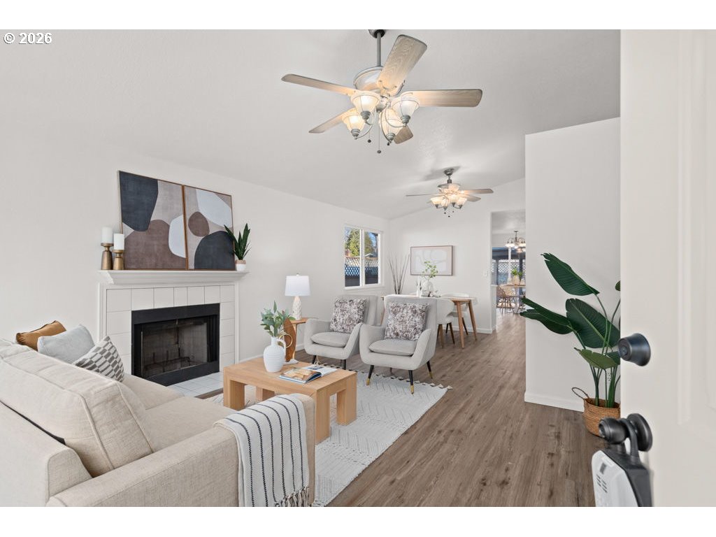 4482 Southwest 179th Avenue Beaverton, OR 97078 - Photo 4 of 37 a living room with furniture chandelier and a fireplace