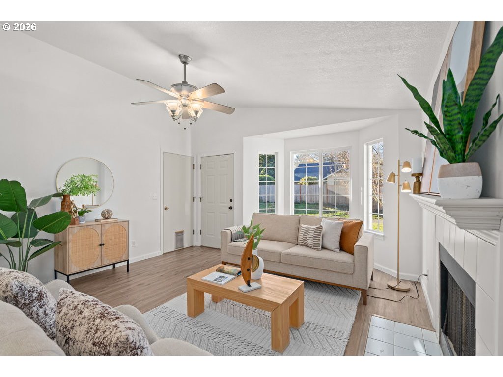 4482 Southwest 179th Avenue Beaverton, OR 97078 - Photo 7 of 37 a living room with furniture a chandelier and a dining table