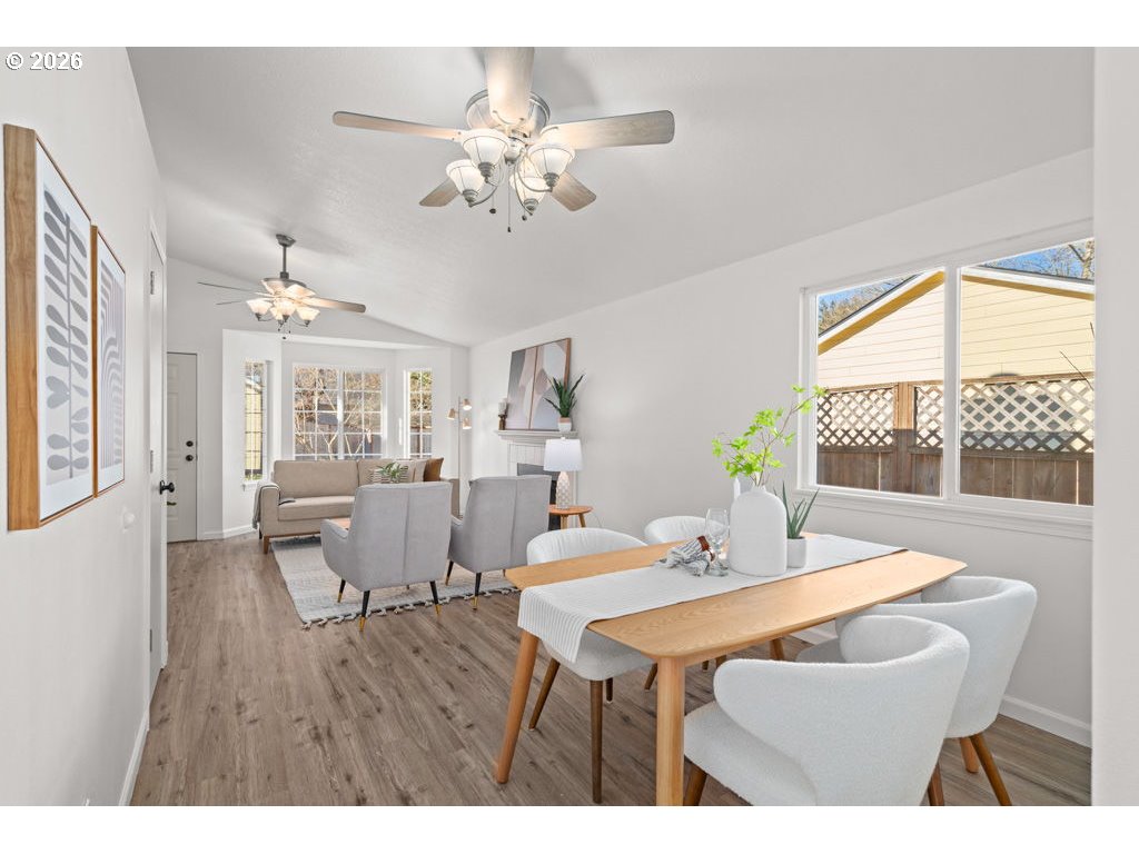 4482 Southwest 179th Avenue Beaverton, OR 97078 - Photo 9 of 37 a dining room with furniture a large window and wooden floor