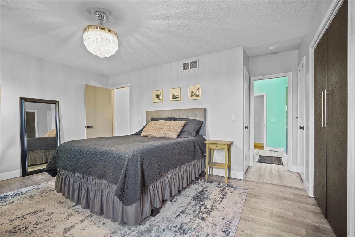 2719 Arrowhead Drive Bloomington, IL 61704 - Photo 11 of 26 a bedroom with a bed and a chandelier