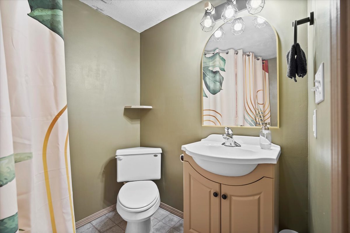 2719 Arrowhead Drive Bloomington, IL 61704 - Photo 19 of 26 a bathroom with a sink a toilet and a mirror