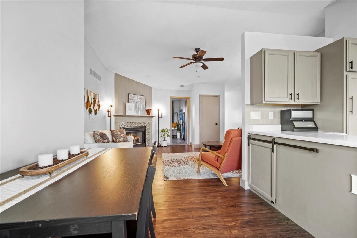 2719 Arrowhead Drive Bloomington, IL 61704 - Photo 6 of 26 a living room with furniture a fireplace and kitchen view