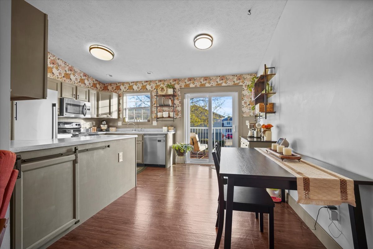 2719 Arrowhead Drive Bloomington, IL 61704 - Photo 7 of 26 a kitchen with a dining table chairs and wooden floor