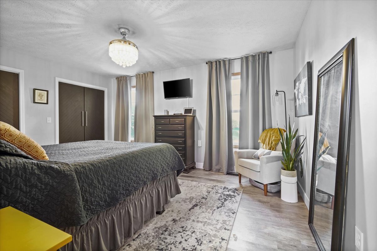 2719 Arrowhead Drive Bloomington, IL 61704 - Photo 10 of 26 a bedroom with a bed and a flat screen tv