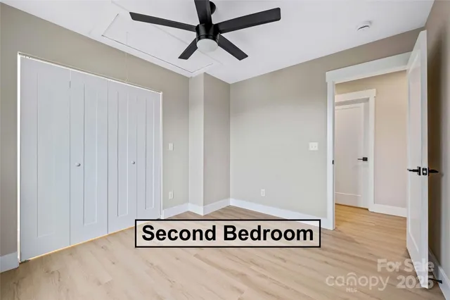 a bedroom with a bed and a potted plant