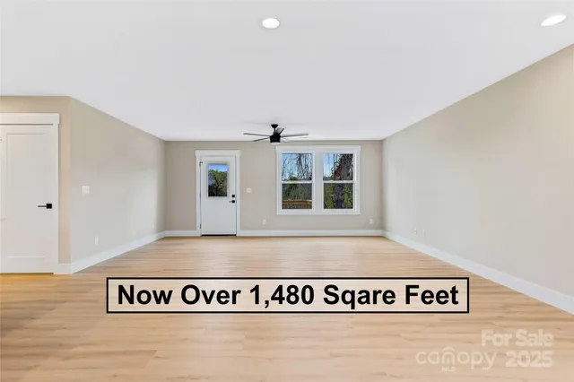 a view of a dining room with furniture a rug and wooden floor