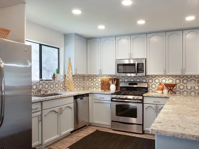 a kitchen with a sink stove and microwave