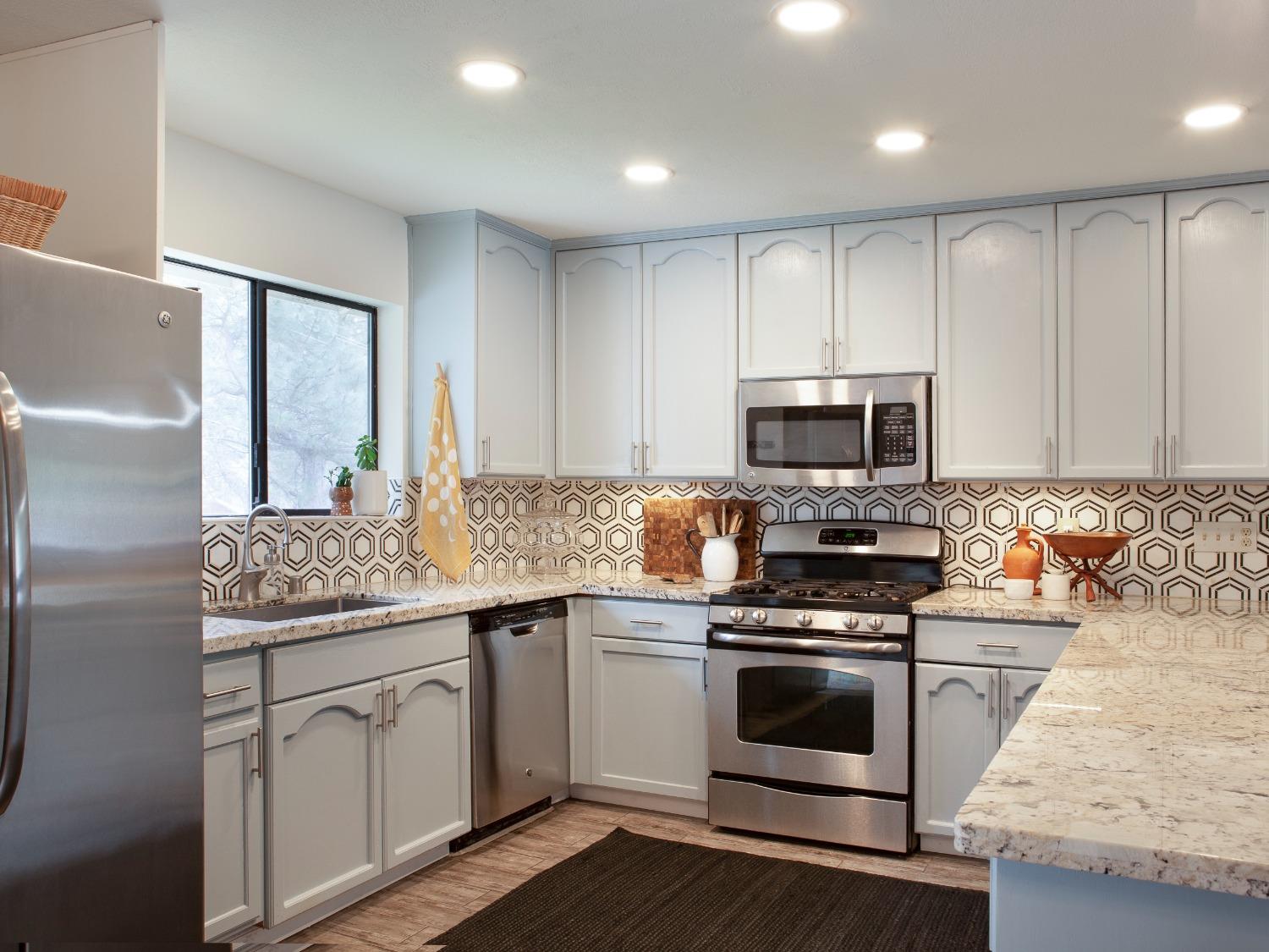 a kitchen with a sink stove and microwave