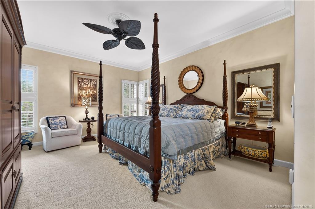 12500 Harbour Ridge Boulevard, Unit 48 Palm City, FL 34990 - Photo 12 of 28 a bedroom with a bed and a chandelier