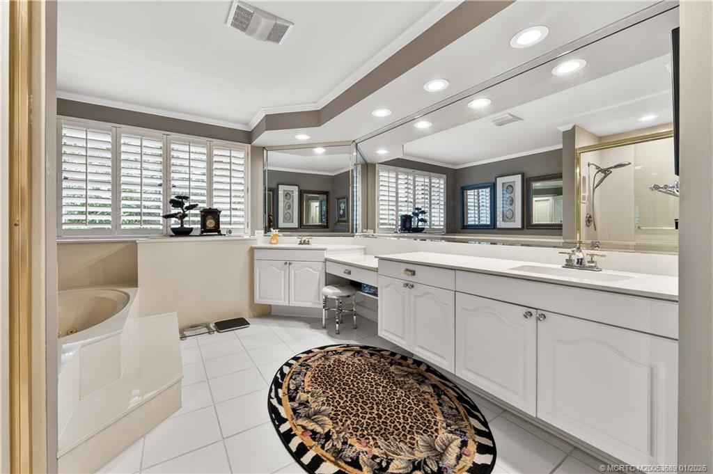 12500 Harbour Ridge Boulevard, Unit 48 Palm City, FL 34990 - Photo 13 of 28 a large bathroom with a large tub sink and window