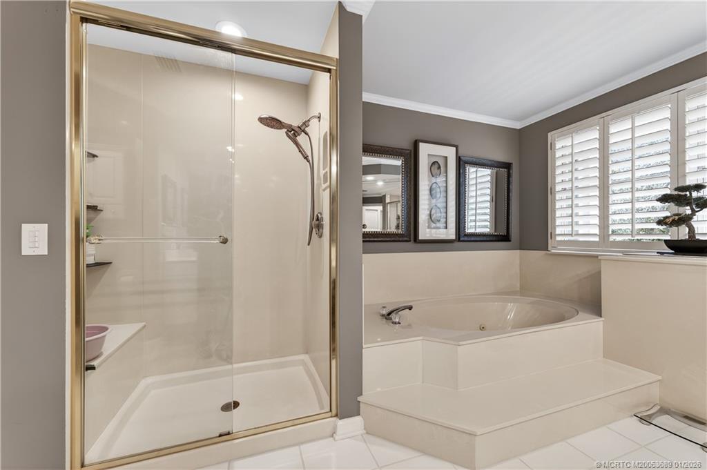 12500 Harbour Ridge Boulevard, Unit 48 Palm City, FL 34990 - Photo 14 of 28 a white bath tub sitting next to a shower