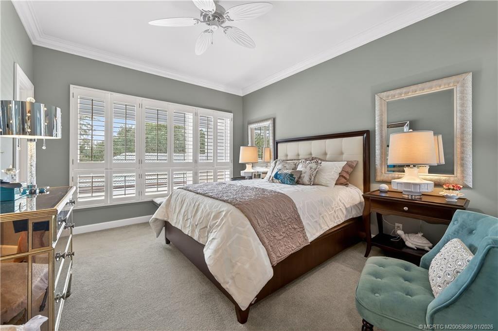 12500 Harbour Ridge Boulevard, Unit 48 Palm City, FL 34990 - Photo 15 of 28 a bedroom with a bed and a chandelier