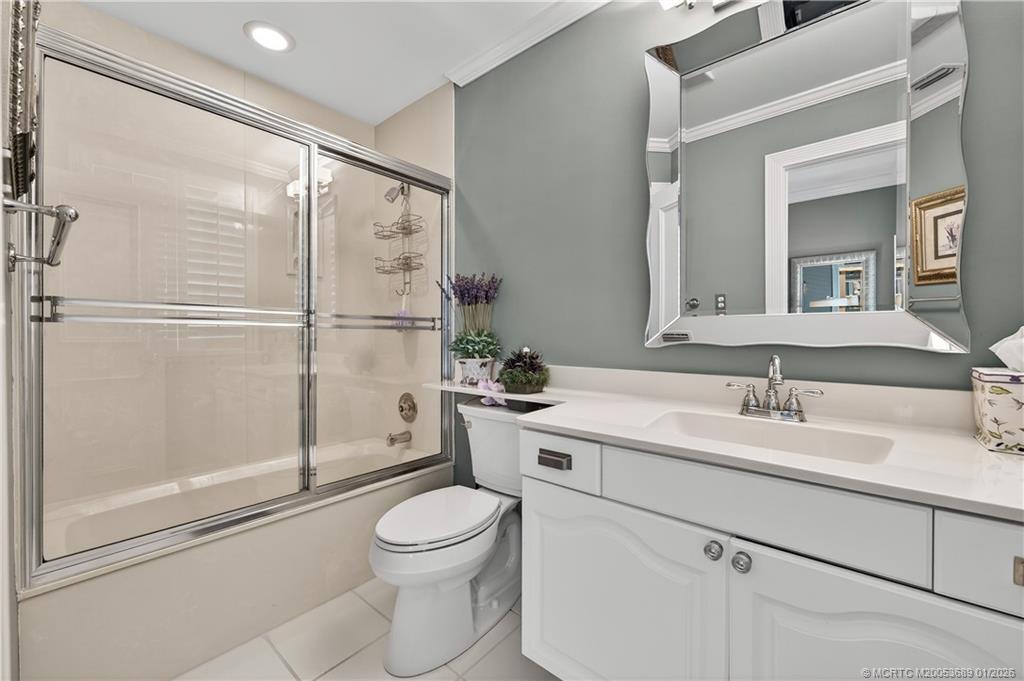 12500 Harbour Ridge Boulevard, Unit 48 Palm City, FL 34990 - Photo 16 of 28 a bathroom with a sink a mirror and a shower