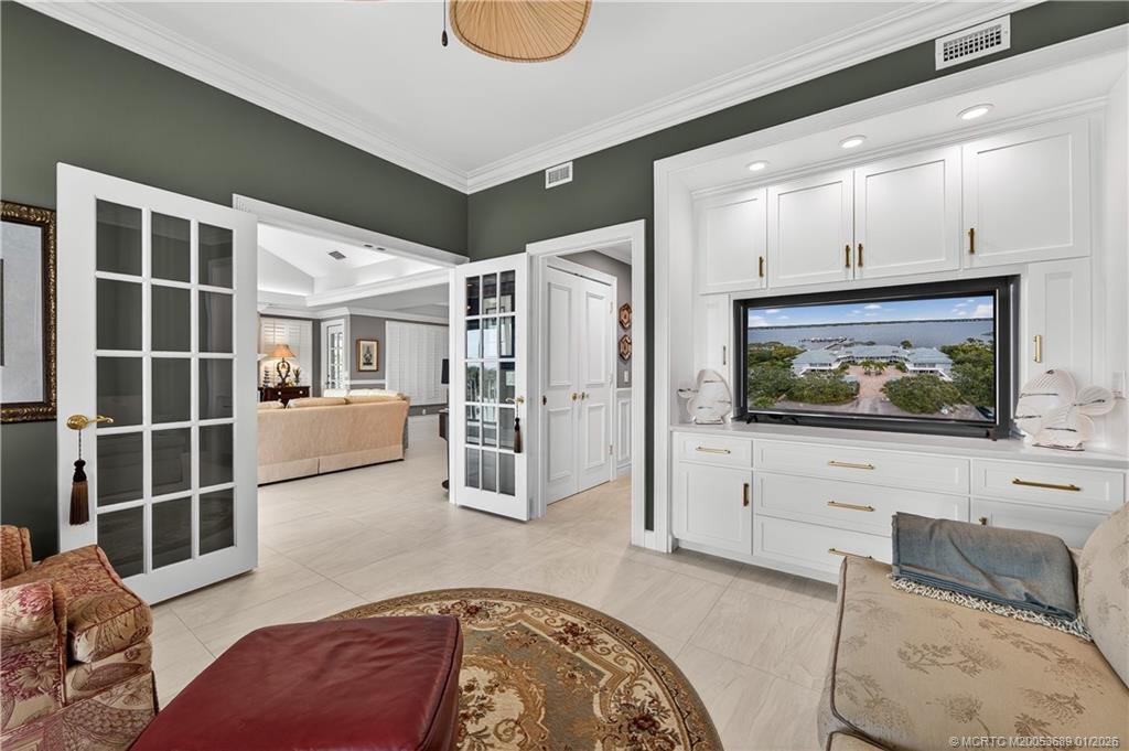 12500 Harbour Ridge Boulevard, Unit 48 Palm City, FL 34990 - Photo 18 of 28 a living room with furniture and a flat screen tv