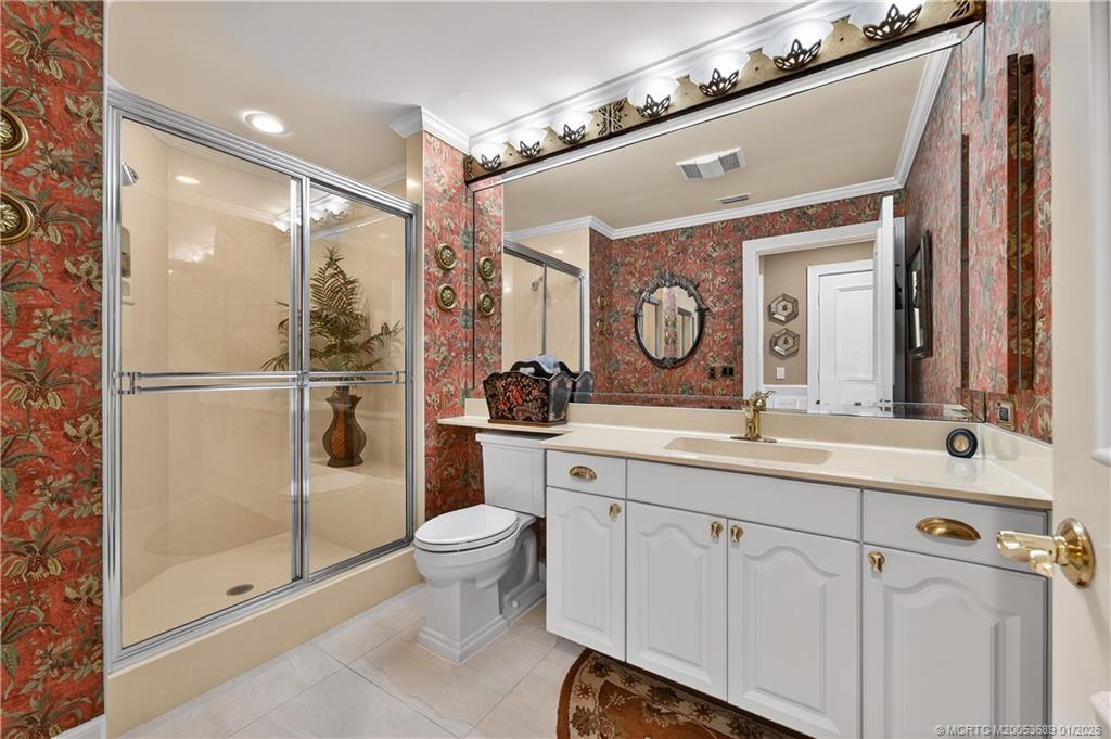 12500 Harbour Ridge Boulevard, Unit 48 Palm City, FL 34990 - Photo 19 of 28 a bathroom with a toilet a sink and mirror