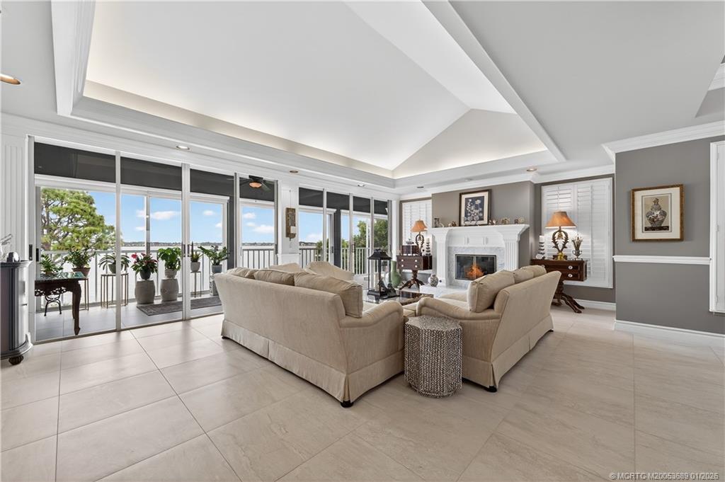 12500 Harbour Ridge Boulevard, Unit 48 Palm City, FL 34990 - Photo 5 of 28 a living room with furniture and a large window