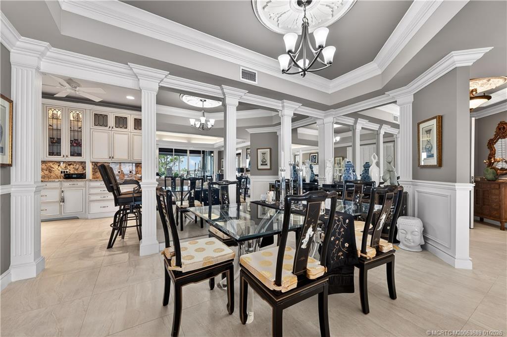 12500 Harbour Ridge Boulevard, Unit 48 Palm City, FL 34990 - Photo 6 of 28 a view of a dining room with furniture and chandelier