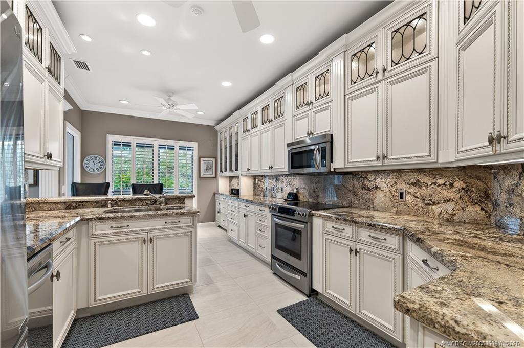 12500 Harbour Ridge Boulevard, Unit 48 Palm City, FL 34990 - Photo 8 of 28 a kitchen with stainless steel appliances granite countertop a stove and a sink
