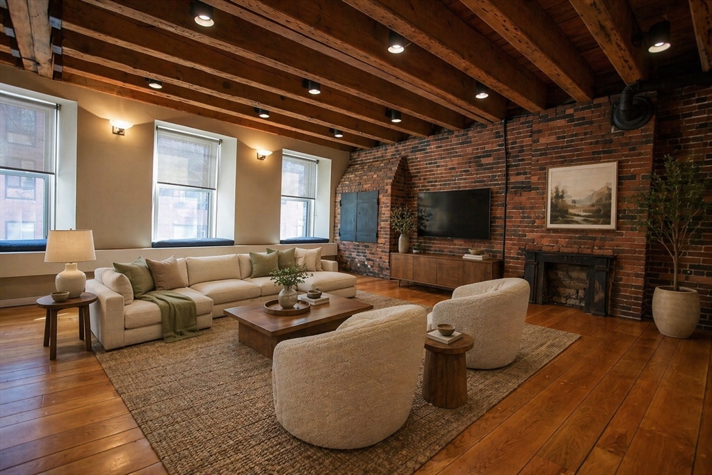 154 Commercial Street, Unit 2 Boston, MA 02109 - Photo 1 of 6 a living room with furniture wooden floor and a flat screen tv