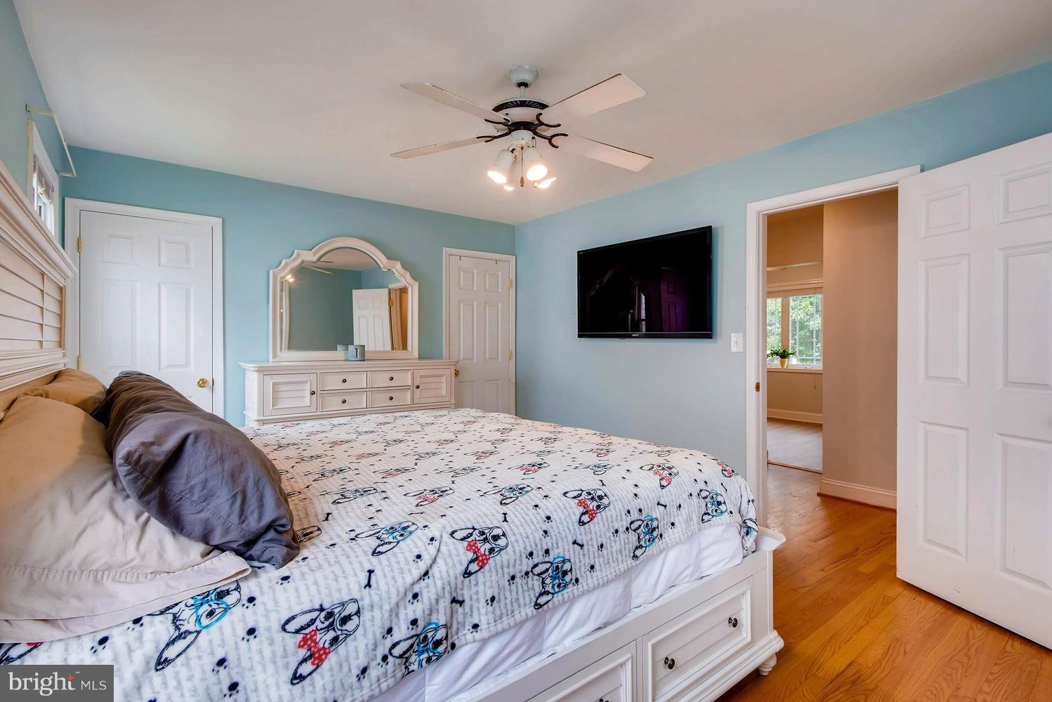 3106 River Drive Road Baltimore, MD 21219 - Photo 14 of 30 a bedroom with a large bed and a flat tv screen on dresser