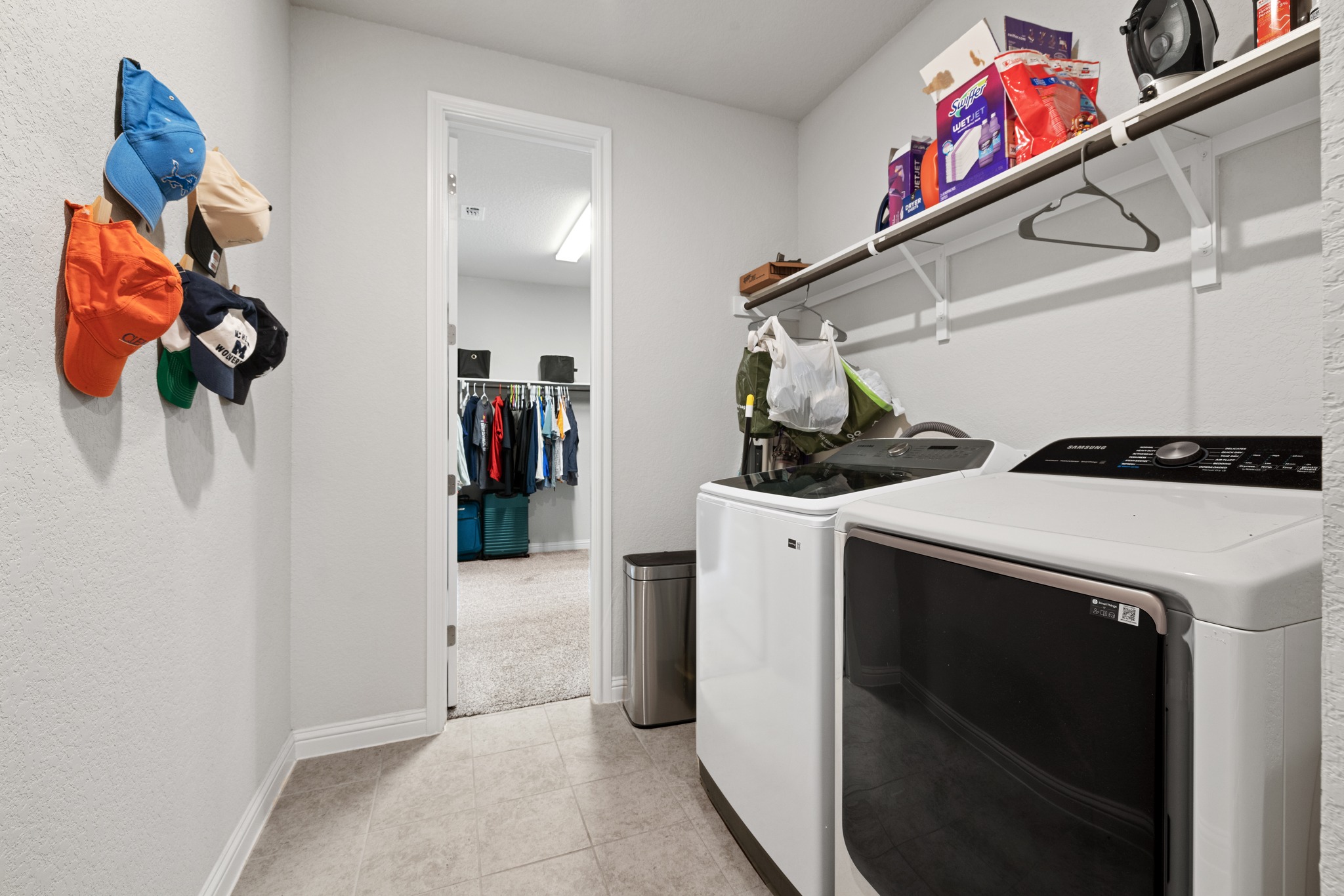8405 Hubble Walk Austin, TX 78744 - Photo 25 of 36 Laundry room with washing machine and dryer, light tile patterned floors, and a textured wall