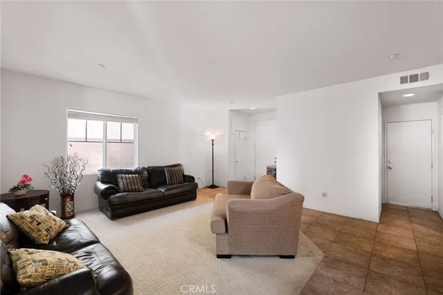 a living room with furniture and stairs