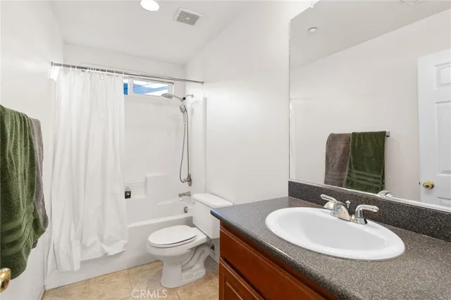 a bedroom with a bed and a mirror