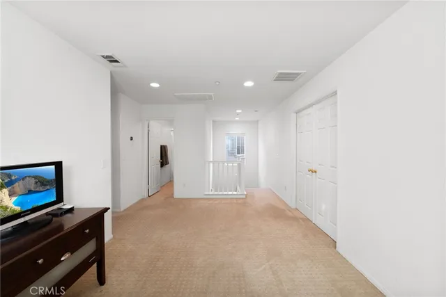 a view of a patio with a table and chairs and potted plants