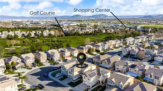 a kitchen with stainless steel appliances granite countertop a refrigerator a sink dishwasher a stove a dining table and chairs with wooden floor