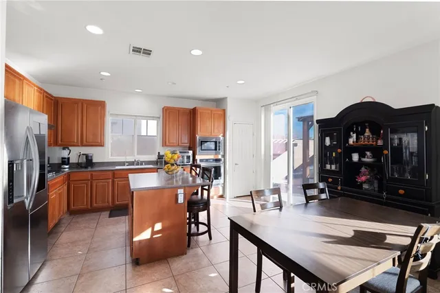 a kitchen with stainless steel appliances granite countertop a refrigerator sink and cabinets