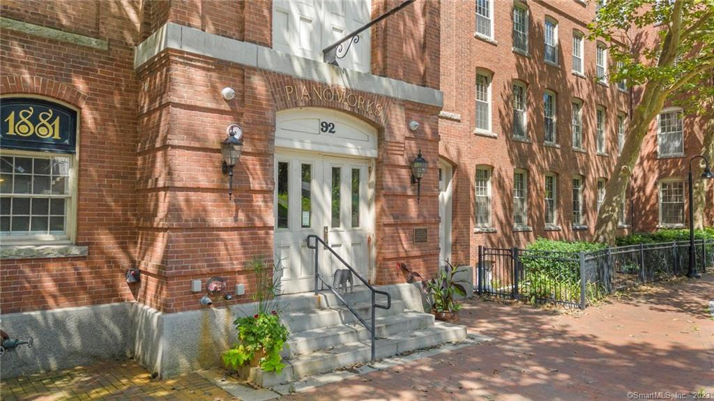 92 Main Street, Unit 403 Deep River, CT 06417 - Photo 1 of 1 a view of a brick building with many windows