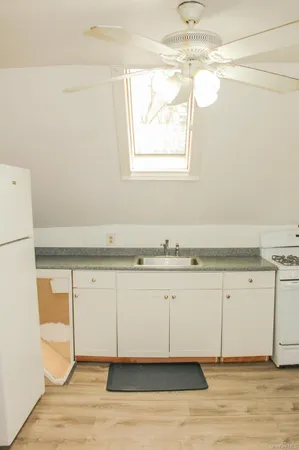a view of a kitchen with a stove top oven