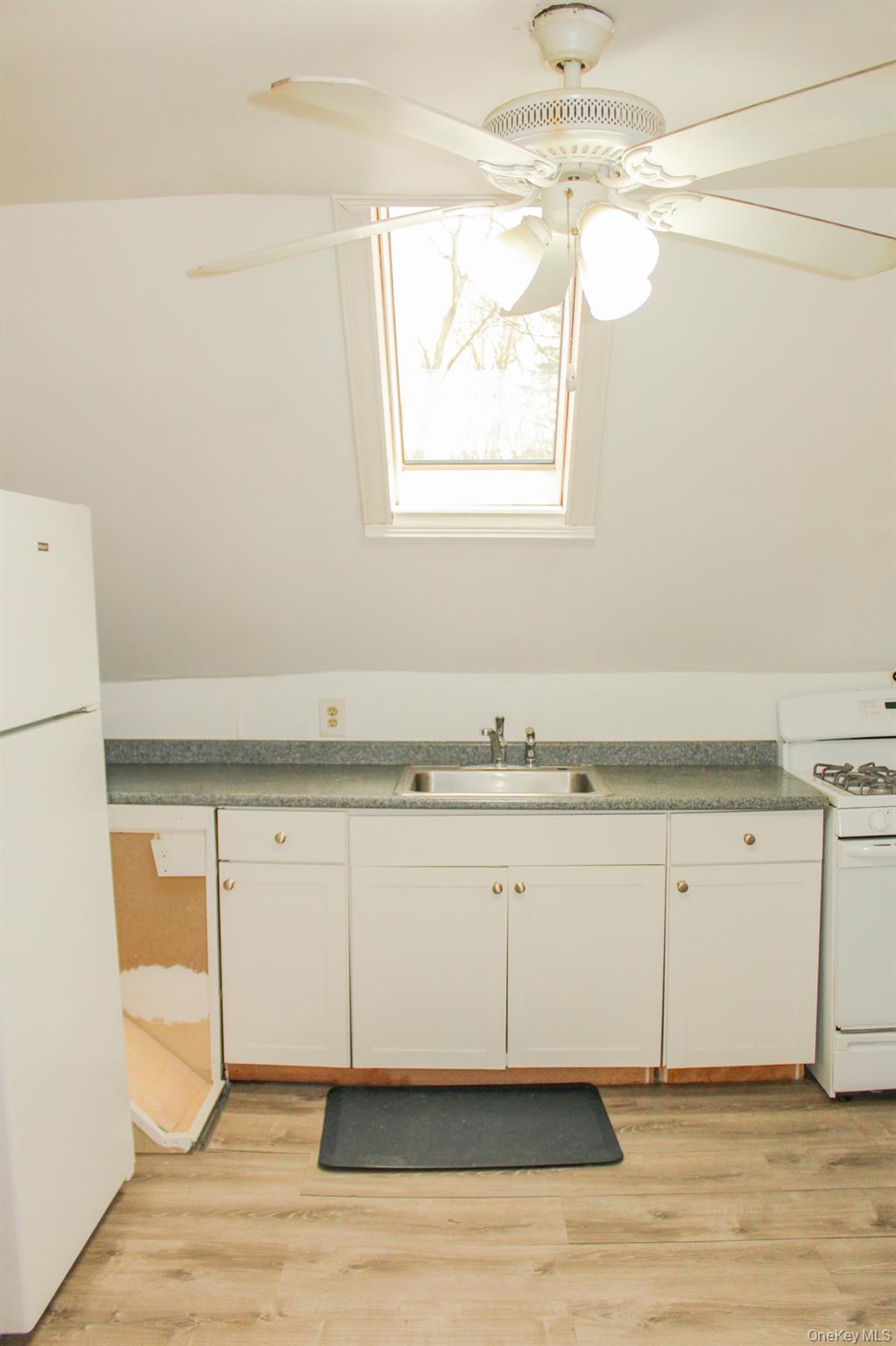 29 Schultz Road White Lake, NY 12786 - Photo 25 of 28 a view of a kitchen with wooden floor and a sink
