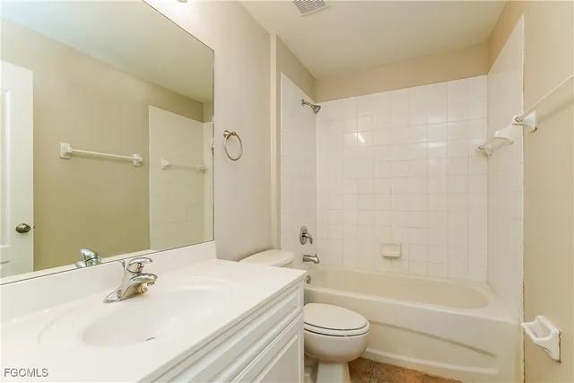 a bathroom with a sink mirror toilet and bathtub