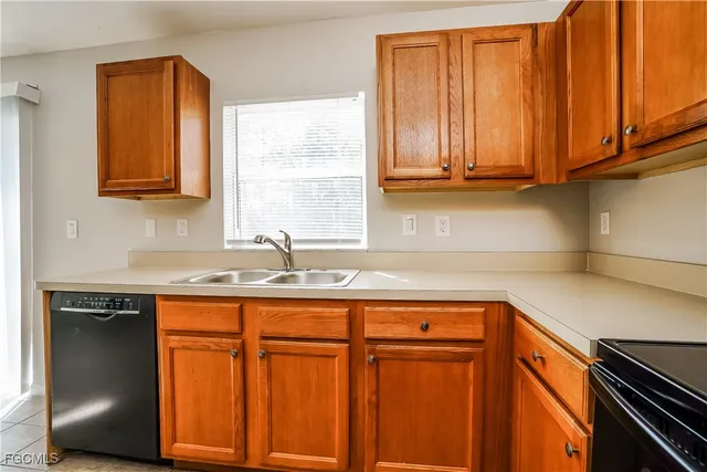 a kitchen with stainless steel appliances granite countertop wooden cabinets a sink and a dishwasher