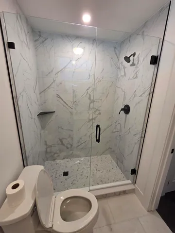 an empty room with windows and cabinet