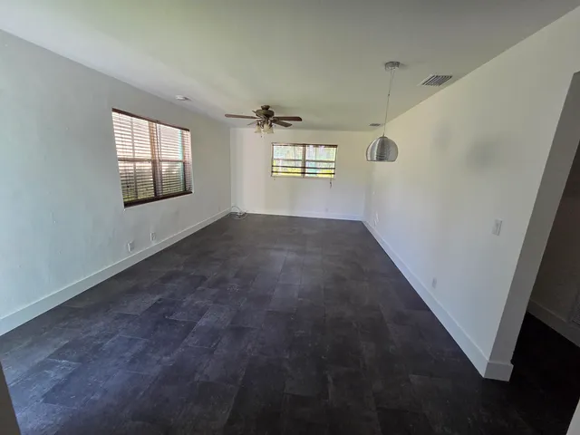 a kitchen with granite countertop a refrigerator and a sink