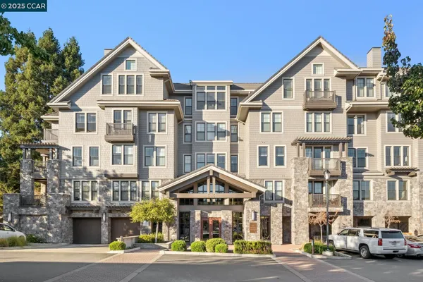 a front view of a residential apartment building with a yard