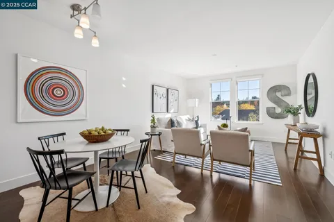 a view of a dining room with furniture a chandelier and wooden floor
